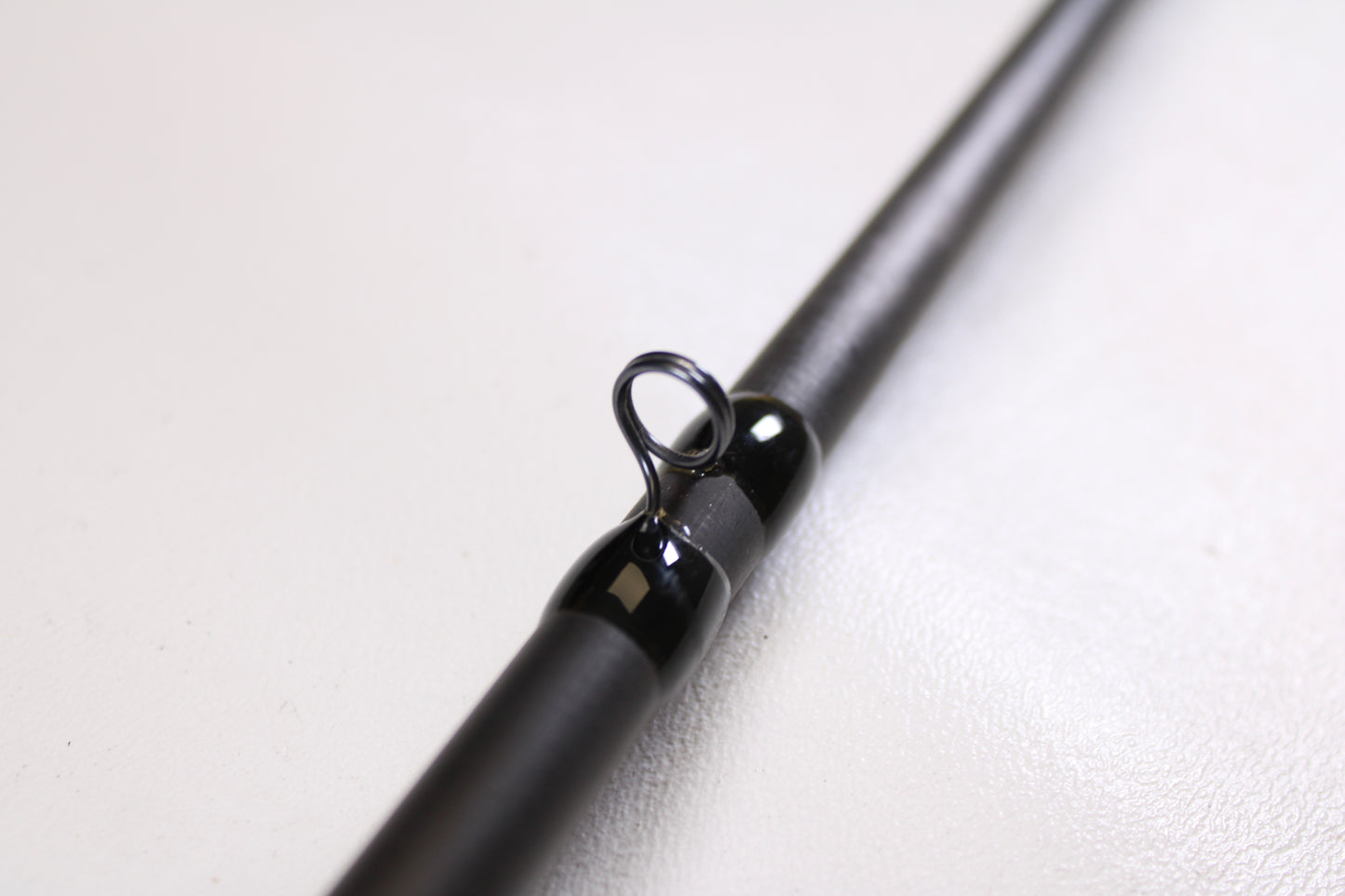 Close-up of a 13 Fishing Envy Black EBC76H 7'6" Heavy used casting rod in very good condition, highlighting the line guide—an ideal choice for our Rod and Reel Trade-In Program.