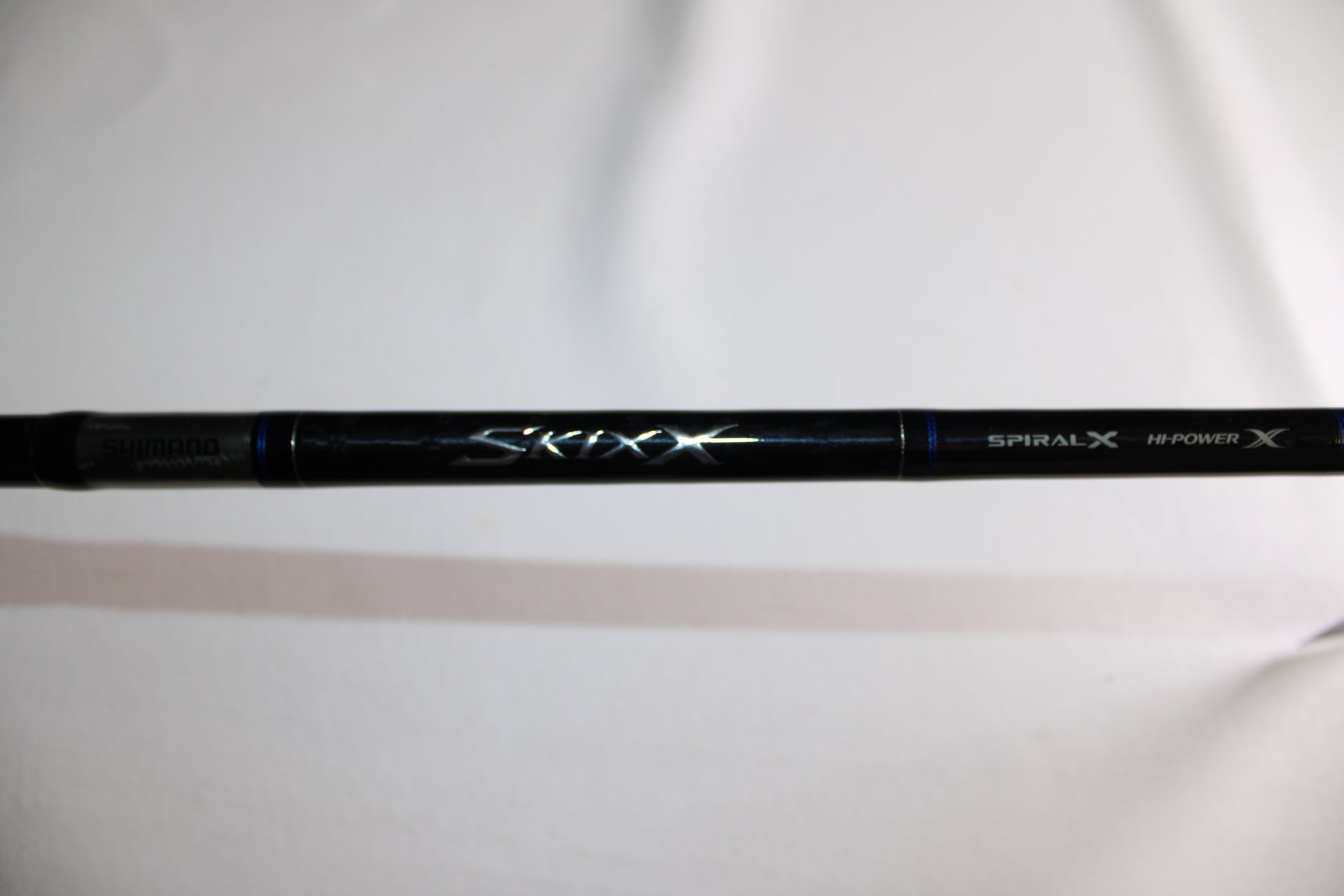 A black Shimano SKIXX SKC80XH Used Casting Rod (Mint Condition) displays "Shimano," "Spiral X," "Hi-Power X," and "Skixx" on its blank, set against a white background—ideal for used gear enthusiasts or our trade-in program.