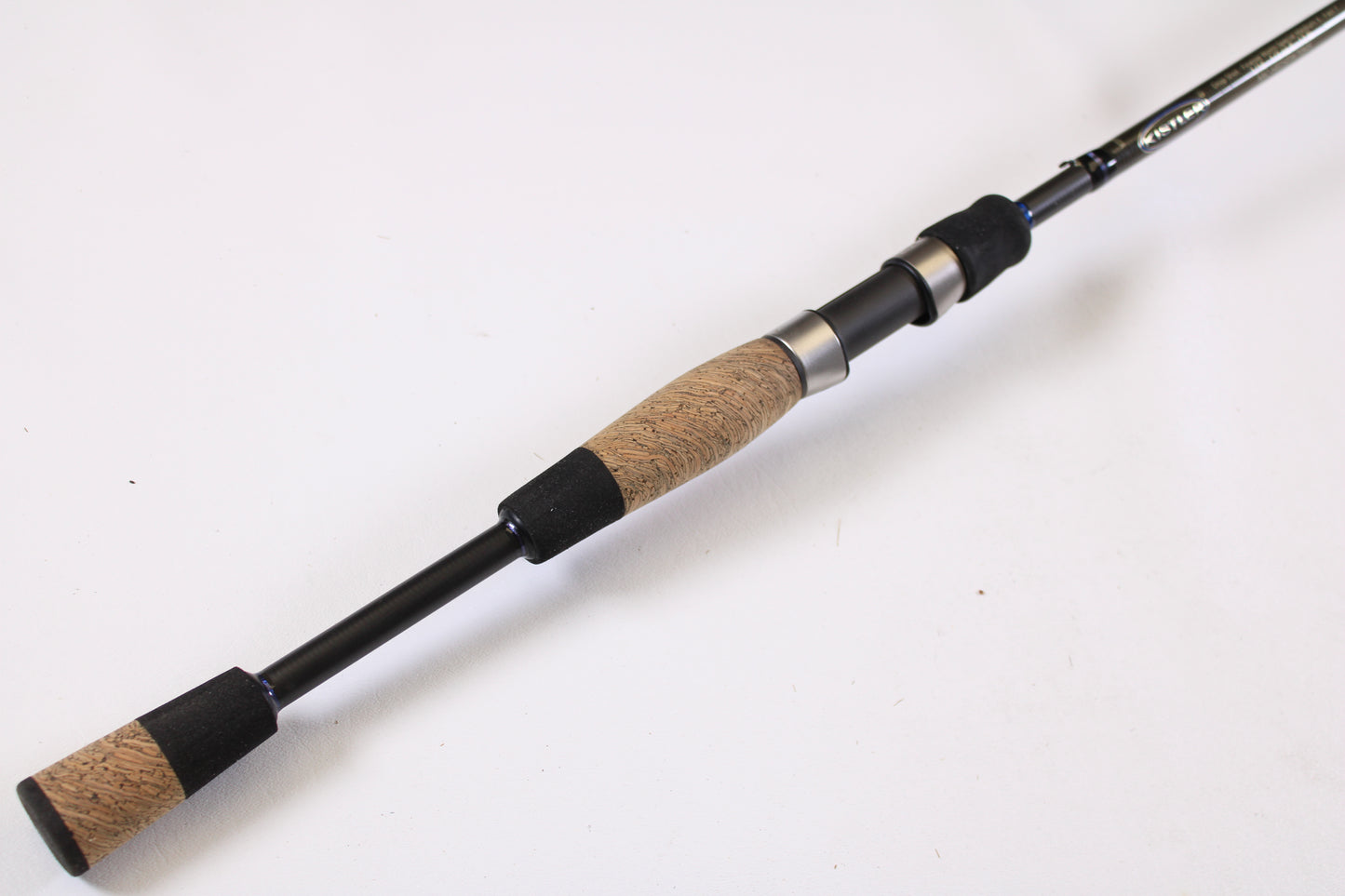 A close-up of the Kistler Helium LTA MIC-HEDSFW70MS 7'0" Medium used spinning rod’s handle shows its quality cork and foam grip—perfect for those using our Rod and Reel Trade-In Program or upgrading with store credit for used Kistler gear.