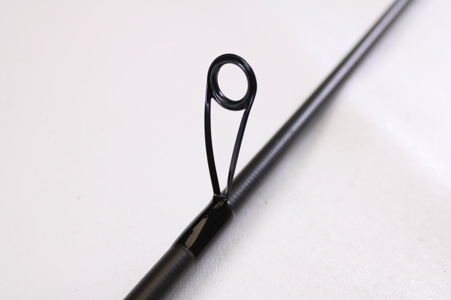 Close-up of the Kistler Helium LTA MIC-HEDSFW70MS 7'0" Medium Used Spinning Rod in very good condition, showing its guide—eligible for trade-in through our Rod and Reel Trade-In Program for store credit.