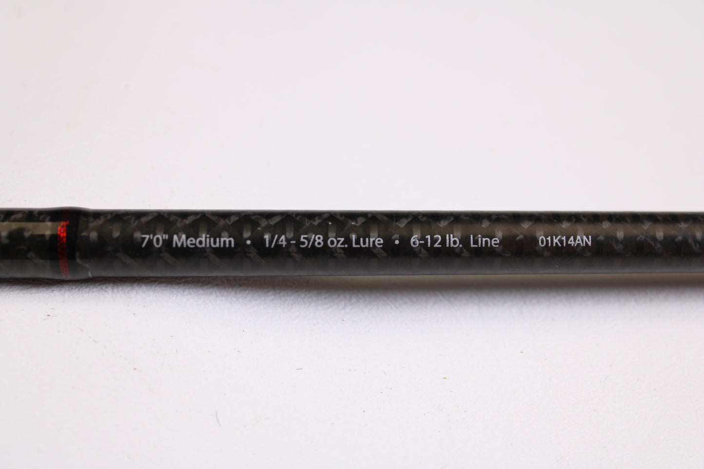 A close-up of an Abu Garcia Fantasista Regista FNRS70-5 7'0" Medium Used Spinning Rod in very good condition, showing specs on its black carbon fiber surface—ideal for our Rod and Reel Trade-In Program for store credit.