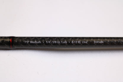 A close-up of an Abu Garcia Fantasista Regista FNRS70-5 7'0" Medium Used Spinning Rod in very good condition, showing specs on its black carbon fiber surface—ideal for our Rod and Reel Trade-In Program for store credit.