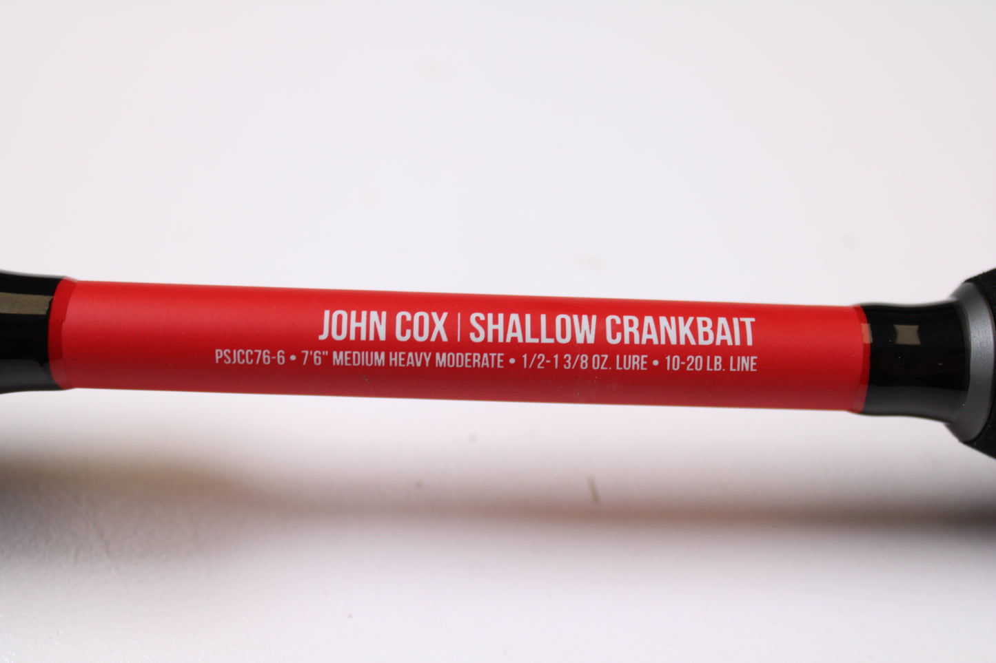 Close-up of Abu Garcia Pro Series PSJCC76-6 John Cox Shallow Crankbait 7'6" Medium Heavy Used Casting Rod—Excellent Condition—shows specs in white text. Great for used gear seekers or store credit with our Rod and Reel Trade-In Program.