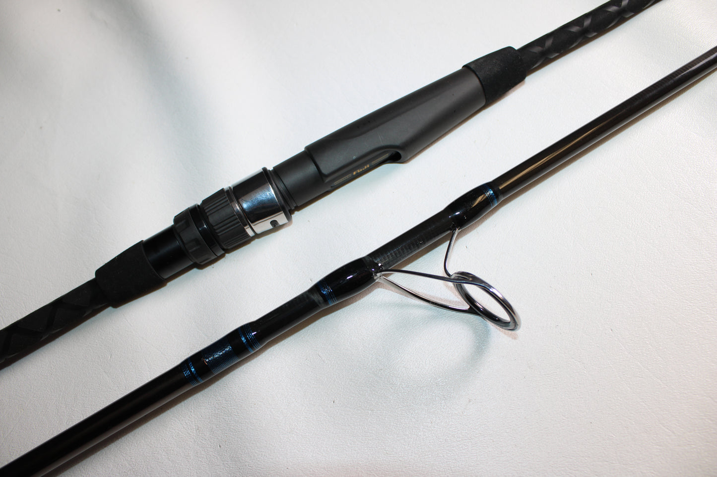 A close-up of the Tsunami Air Wave Elite TSAWESS802LT 8'0" 2-piece used spinning rod in excellent condition—ideal for those looking to trade in gear through our Rod and Reel Trade-In Program for store credit.