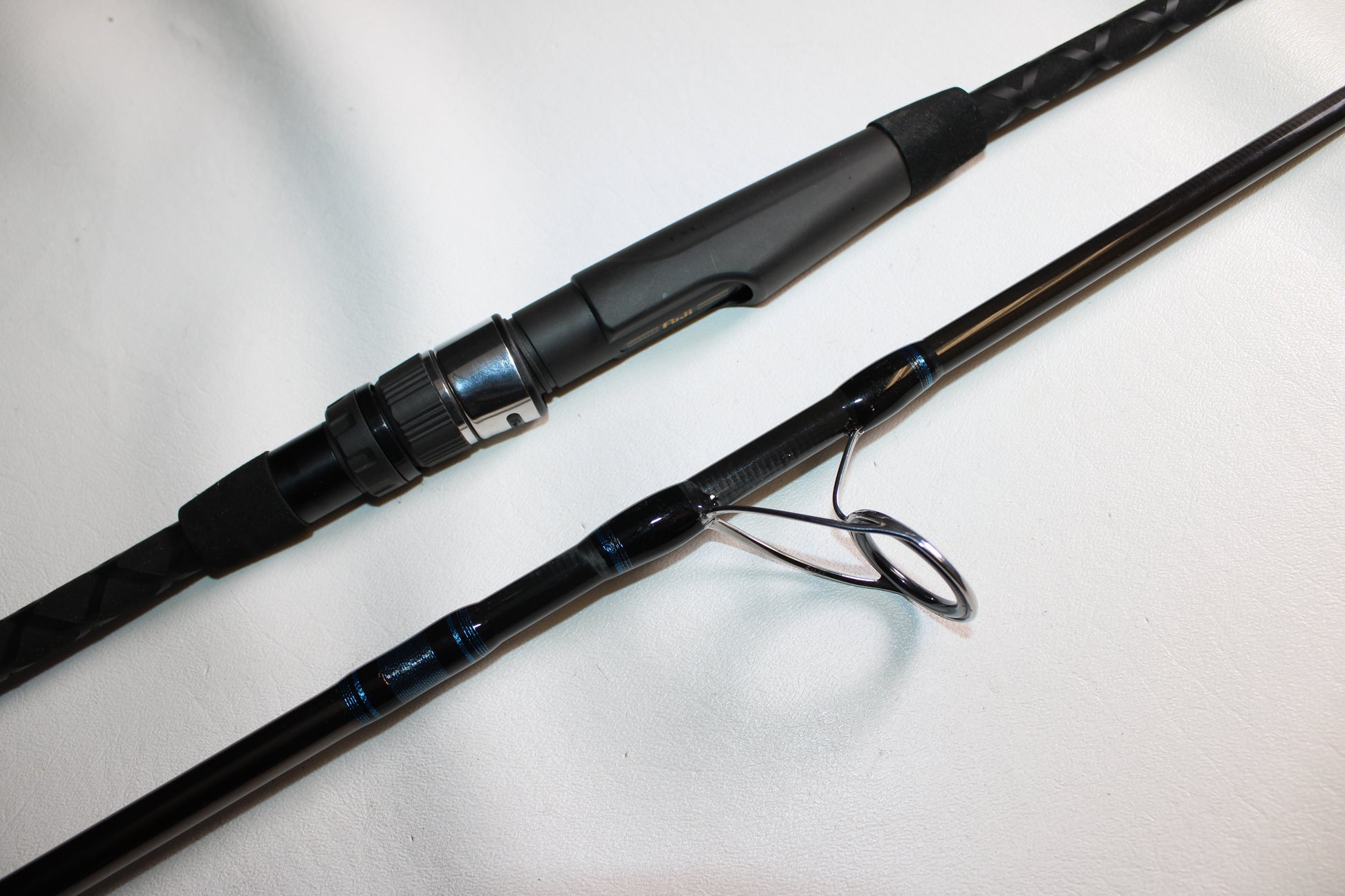 A close-up of the Tsunami Air Wave Elite TSAWESS802LT 8'0" 2-piece used spinning rod in excellent condition—ideal for those looking to trade in gear through our Rod and Reel Trade-In Program for store credit.