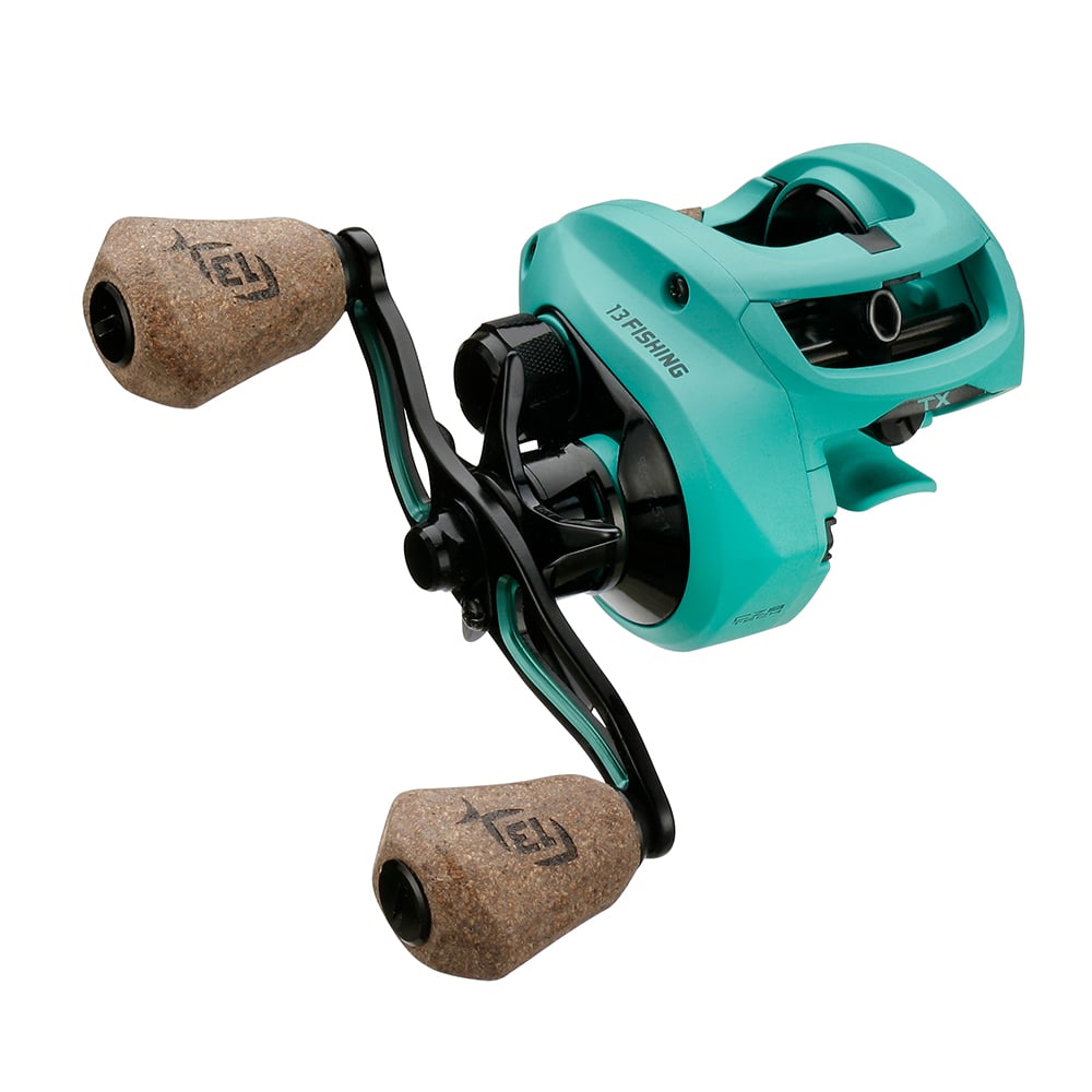 The 13 Fishing Concept TX2 Casting Reel 6.8:1 (TX2-6.8-RH) features teal housing, two large cork handles, and black metal components, displayed at an angle on a white background.