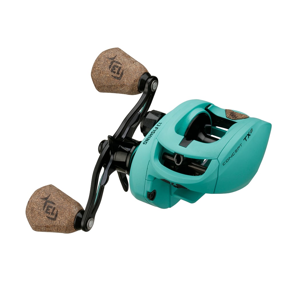 A 13 Fishing Concept TX2 Casting Reel 7.5:1 (TX2-7.5-RH), teal with two tan cork handles and black corrosion-resistant metal parts, labeled "Concept TX2" and "13 Fishing.