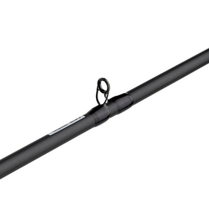 Close-up of an Abu Garcia Veritas Tournament Casting Rod 7'3" Heavy (VXTC73-7) with a black matte finish and metal guide loop. A small label is near the guide, and the tip blends into the plain white background.