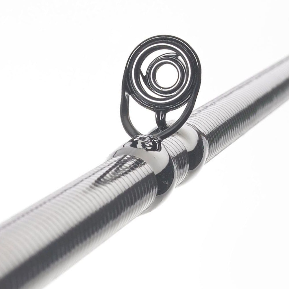Close-up of a Cashion Rods John Crews ICON Series Casting Rod Worming 7'2" Medium Heavy guide, highlighting the circular metal ring, its support, and detailed coils against a white background.