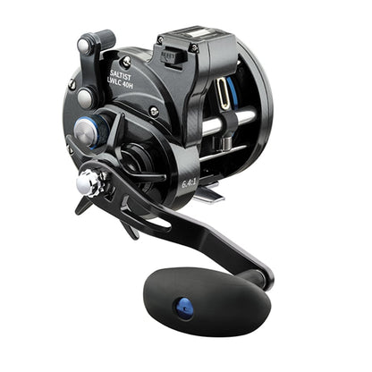 The Daiwa Saltist Levelwind Line Counter Conventional Reel 50LCH, resting against a white backdrop, features a sturdy handle and metallic accents. With its sleek design and 6.4:1 gear ratio, it is ideal for precise angling.