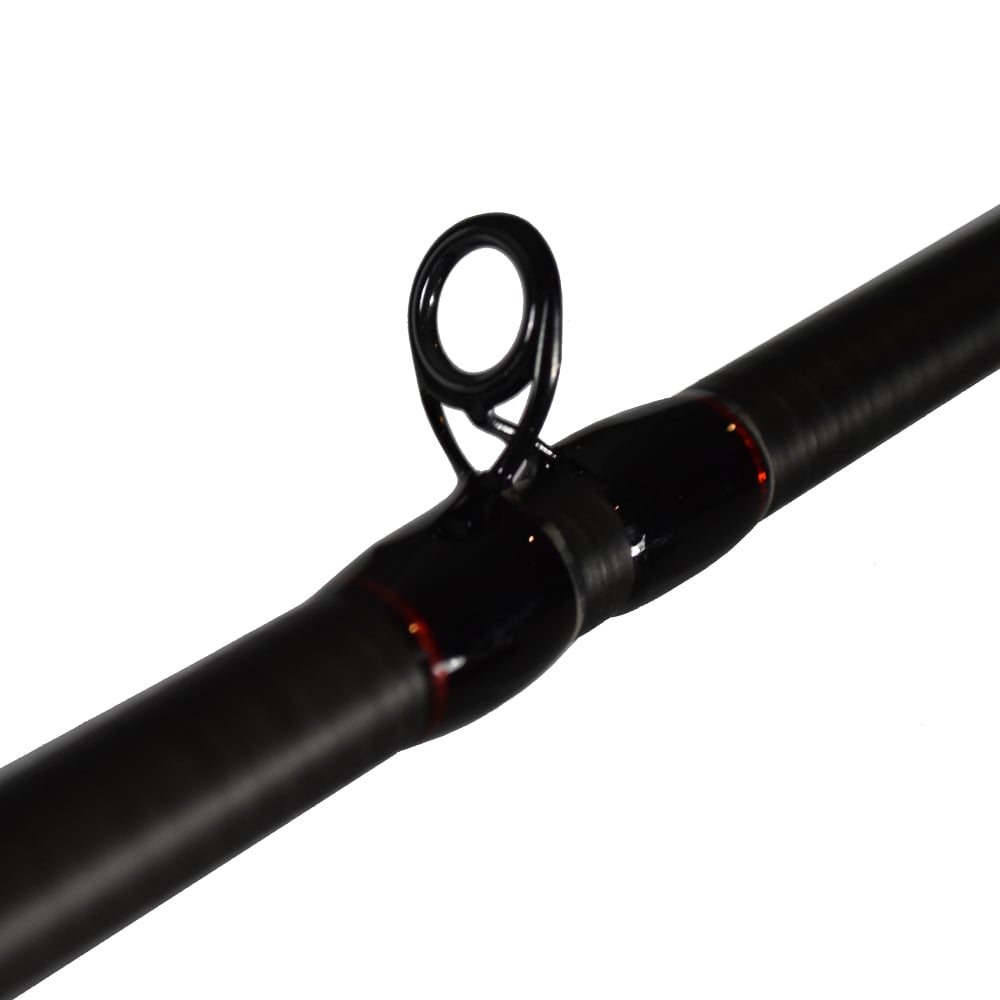 Close-up of the Dobyns Kaden Casting Rod KD 743C, a 7'4" medium-heavy rod crafted from high modulus graphite. It features black and red accents with guide rings and ferrules against a white backdrop.