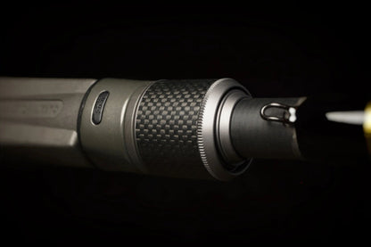 Close-up of the Falcon Cara Casting Rod Deep Runner 7'3" Medium Heavy (CC-5-173DR) tip, showcasing a metallic, textured grip and sharp hooked element—carbon fiber crafted—set against a dark background.