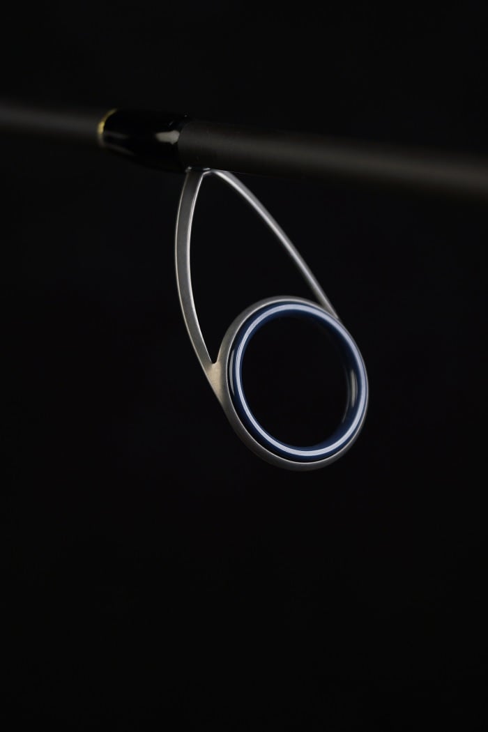 Close-up of the Falcon Cara Spinning Rod MH Spin 7'3" Medium Heavy (CS-5-173) guide with Fuji components, showcasing its metallic ring and frame against a black background.