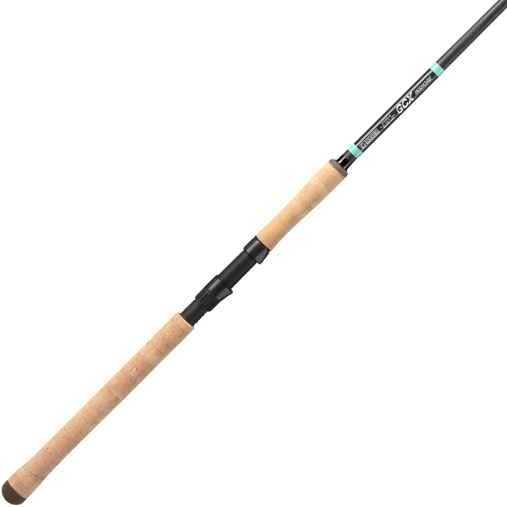 The G. Loomis GCX Inshore Spinning Rod 965S MF 8'0" Extra Heavy features cork handles and a black reel seat, shown diagonally on a white background. Designed for saltwater anglers seeking comfort and easy handling.