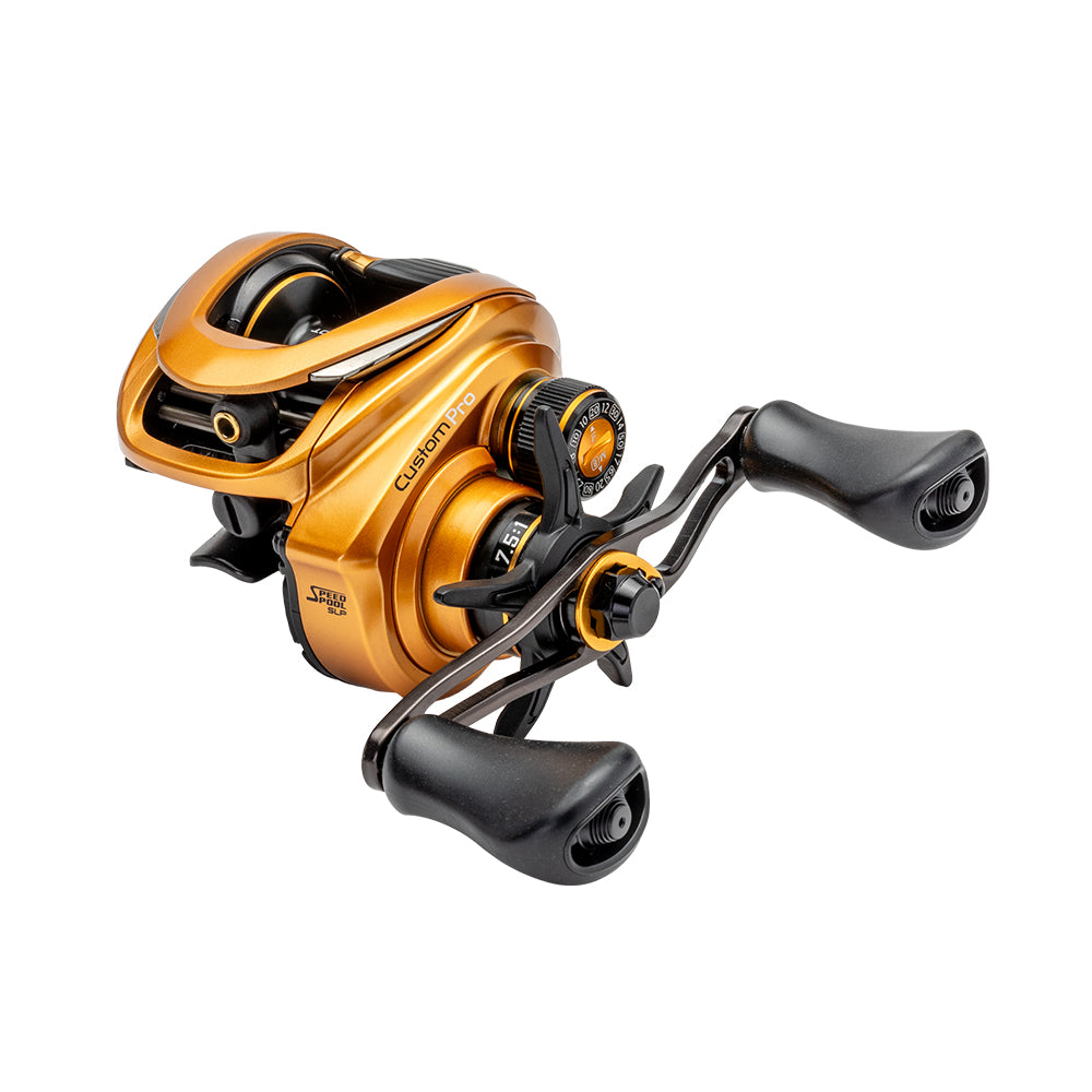 A Lew's Custom Pro Gen 3 Casting Reel 7.5:1 LH (CPB1SHLG3) is shown on a white background, featuring gold and black design, ergonomic dual handles, large spool tension knob, Inertia Transfer Braking, and detailed labeling.