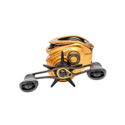 The Lew's Custom Pro Gen 3 Casting Reel 7.5:1 LH (CPB1SHLG3) features a gold finish, dual black handles, a star drag knob, and Inertia Transfer Braking—shown on a white background.