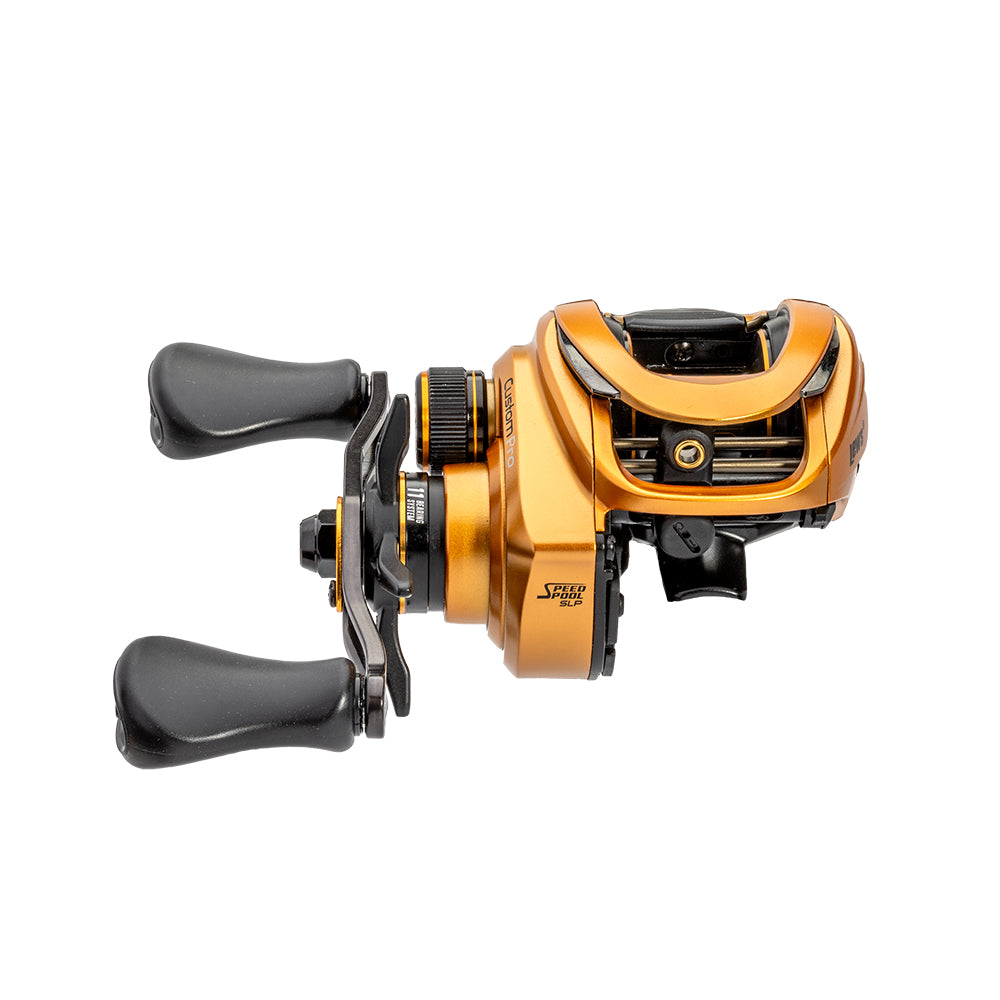 A Lew's Custom Pro Gen 3 Casting Reel 7.5:1 RH (CPB1SHG3) in gold and black, featuring two black handles, is shown from the side against a white background.