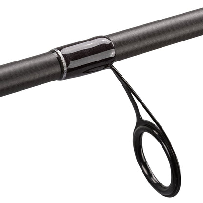 Close-up of the Lew's Team Lew's Signature Series Spinning Rod 6'10" Medium (TLS610MXFS) showing a black metal guide ring on its carbon fiber shaft with FOCAS Blank technology, secured by glossy black thread wraps.