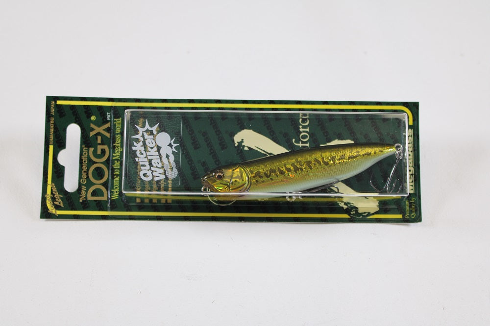 The Megabass Dog-X Quick Walker is a lifelike pencil bait fishing lure with green and yellow coloring, one-knock sound, and comes in green and black branded packaging featuring product details.
