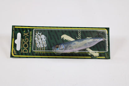 The Megabass Dog-X Quick Walker, a pencil bait fishing lure by Megabass, features a realistic silver-blue fish design with a one-knock sound, packaged on green and yellow striped cardboard.