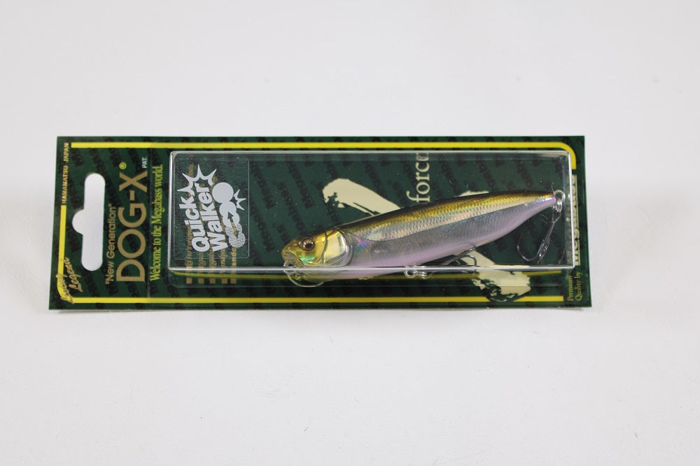 The Megabass Dog-X Quick Walker, by Megabass, is a pencil bait with a lifelike fish design in metallic yellow and silver, packaged on a green and black backing. This lure is noted for its enticing one-knock sound.
