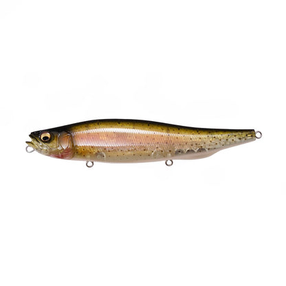 The Megabass Megadog by Megabass is a lifelike, fish-shaped topwater lure featuring a metallic green and gold body, black back, pink gill accents, and detailed eyes—ideal for landing trophy sea bass. Shown on a white background.