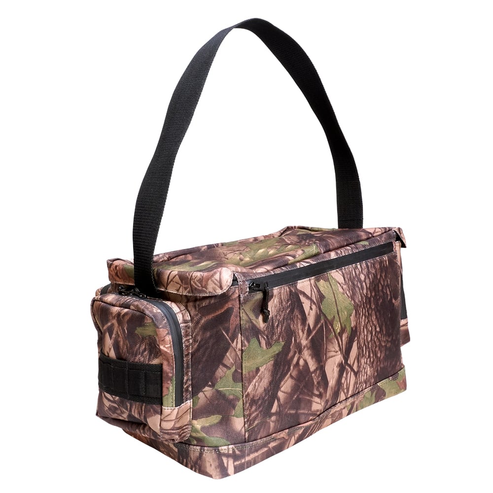The Megabass Survival Bag II is a rectangular, camouflage-patterned military-style tackle bag with a black zipper, side pocket, and wide black shoulder strap for carrying items or fishing gear.
