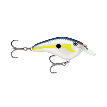 The Rapala OG Slim 6 Crankbait by Rapala is a balsa lure shaped like a small fish, with a blue back, silver sides, yellow stripe, and black dot. It features two treble hooks and a clear plastic lip for diving when bass fishing.