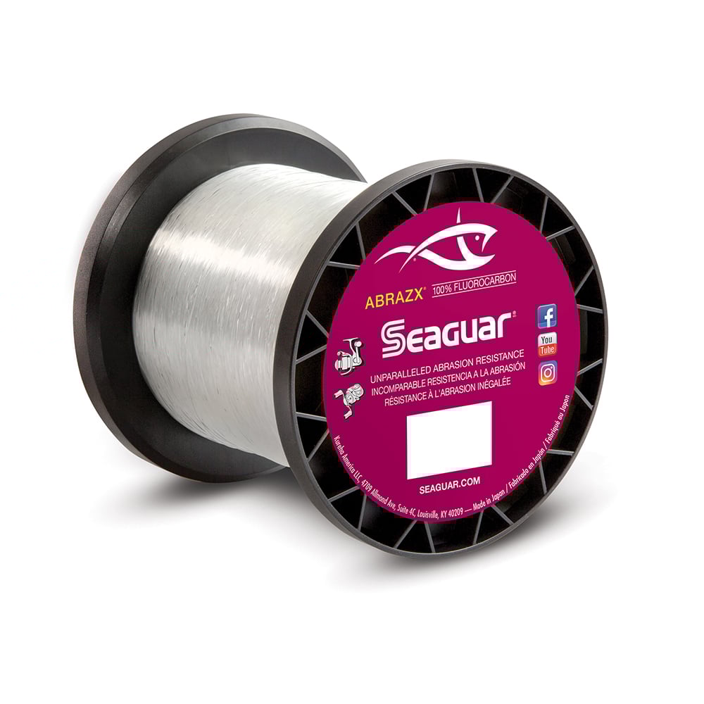 A spool of Seaguar AbrazX Fluorocarbon Line with a transparent design and a black-pink label featuring a fish logo highlights its superior abrasion resistance, perfect for heavy cover conditions.