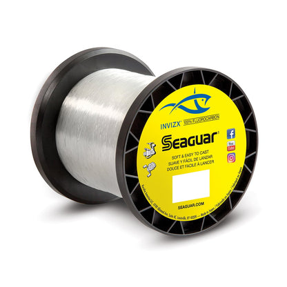 A spool of Seaguar InvizX Fluorocarbon Line from Seaguar features a yellow label adorned with a blue fish logo alongside key product details. The black-rimmed spool holds a clear, almost invisible fishing line perfect for discreet angling.