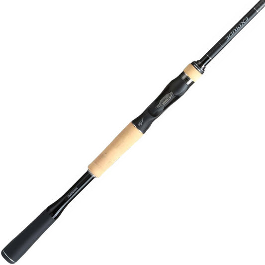 The Shimano Expride B Casting Rod 7'6" Medium Heavy (EXC76MHB) from americanlegacyfishing is a sleek black rod with a cork handle and metallic accents, designed for precision angling with its Carbon Monocoque construction.