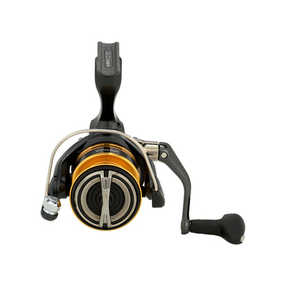 The Shimano Sahara FJ Spinning Reel 3000HGFJ by Shimano, featuring a black body, gold spool, and silver accents, is shown from the front with the handle on the right.