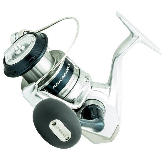 Close-up of a Shimano Saragosa Spinning Reel 5000SWAXG with a sleek design and black handle grip. This silver saltwater reel features Infinity Drive technology and has "SARAGOSA" engraved on it.