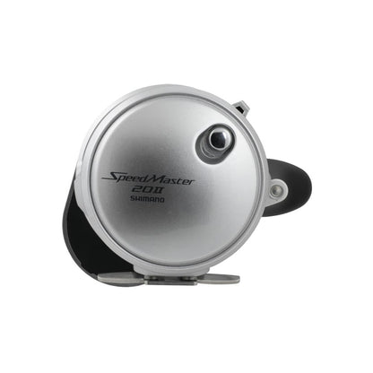 A silver Shimano SpeedMaster 20II 2 Speed Conventional Reel (SPM20II) is shown from the side, displaying the Shimano brand and model name on its round HAGANE metal body.