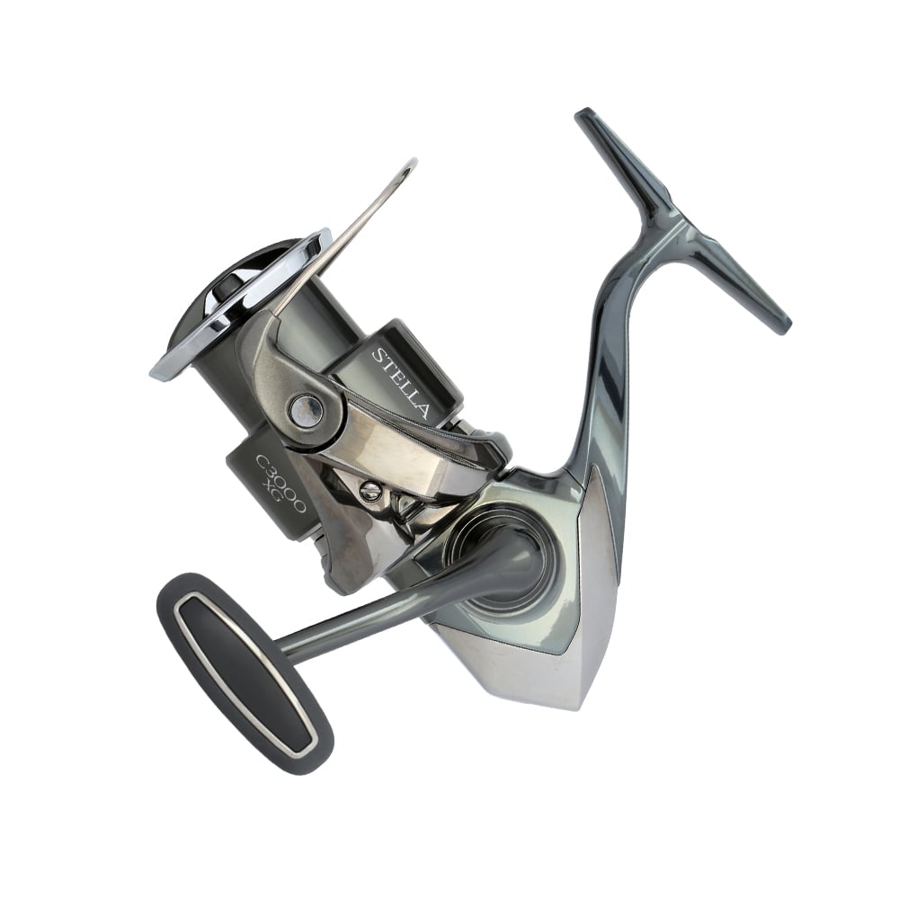 A Shimano Stella FK Spinning Reel 3000XGFK (STLC3000XGFK) in silver and dark gray, with a side crank handle and InfinityDrive technology, displaying the "SHIMANO" brand name on the body, set against a plain white background.