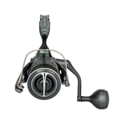 A close-up front view of the Shimano Stella FK Spinning Reel 5000XGFK by Shimano, featuring a black design, metal bail arm, right-side round handle, and advanced reel technology, displayed against a white background.