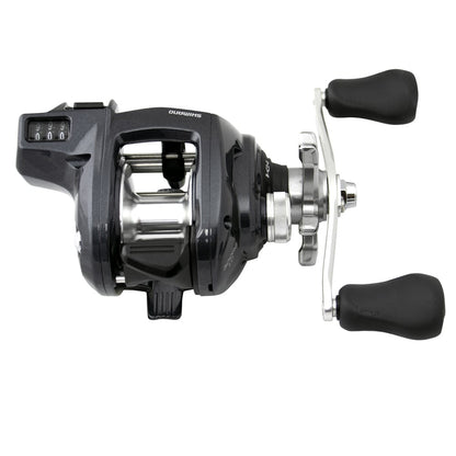 A Shimano Tekota 300HGLCA 6.6:1 Line Counter Casting Reel by Shimano, featuring black and silver design, dual large black handles, spool, and adjustment knobs, shown on a white background.