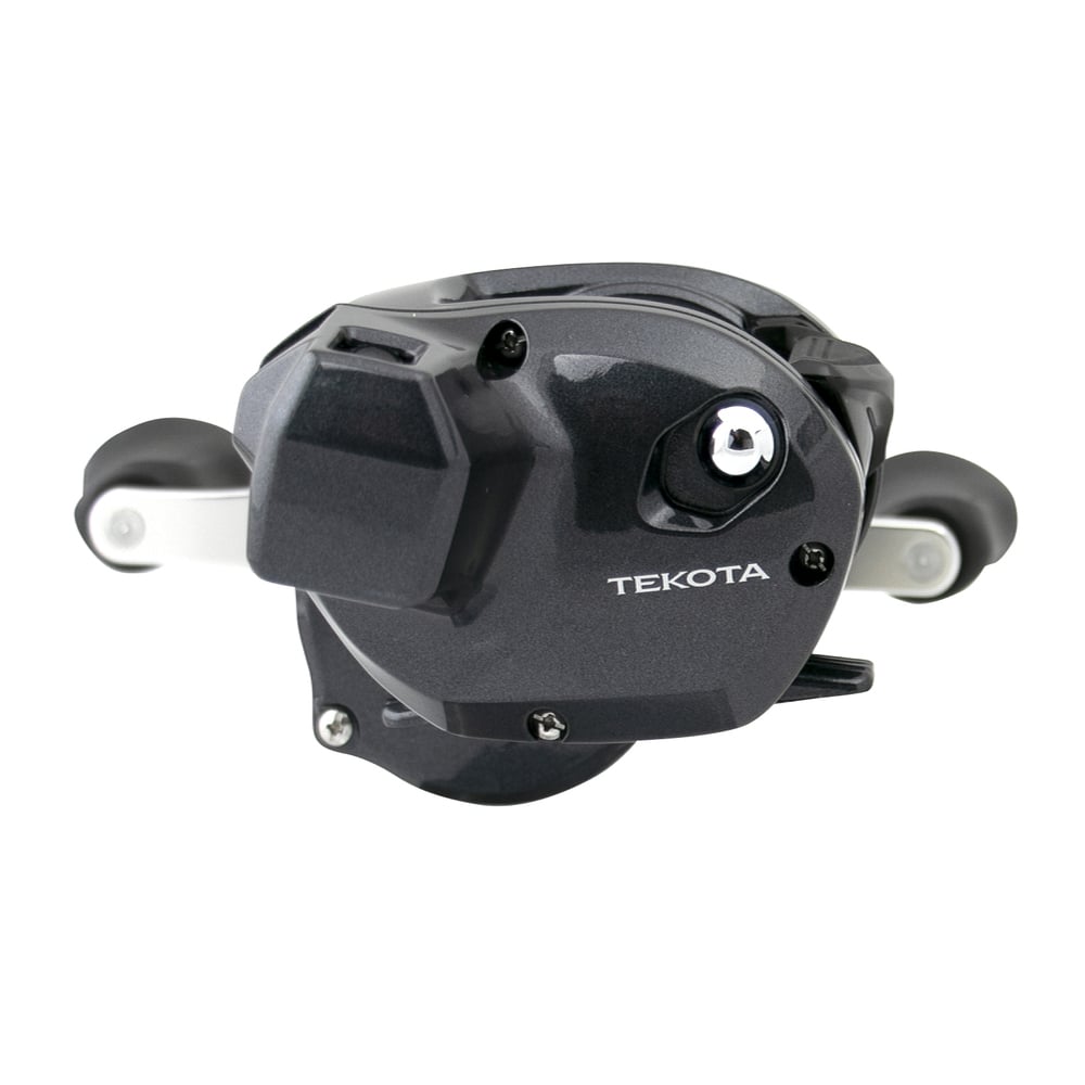 A close-up of the Shimano Tekota 300HGLCA 6.6:1 Line Counter Casting Reel shows its sleek black design, dual handles, and "Tekota" branding on the side. This compact Shimano reel is ideal for precise trolling and casting.