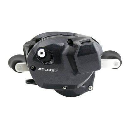 A Shimano Tekota 301HGLCA left hand casting reel with 6.6:1 ratio, dual handles, silver accents, and "TEKOTA" branding is pictured on a white background.