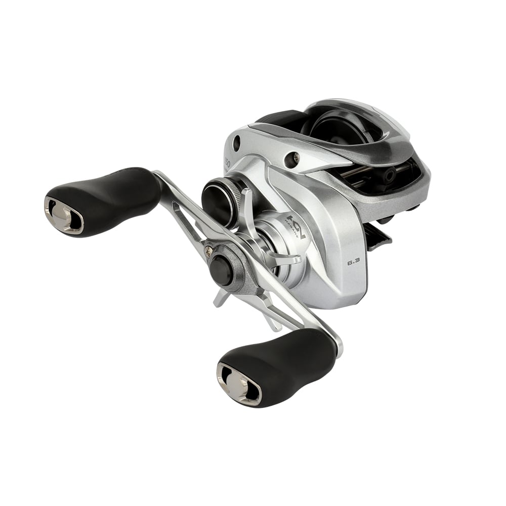 The Shimano Tranx 150A Casting Reel 6.3:1 Right Hand (TRX150A) by Shimano features a sleek silver finish with two black handles and metal components, shown on a white background—perfect for saltwater fishing enthusiasts.