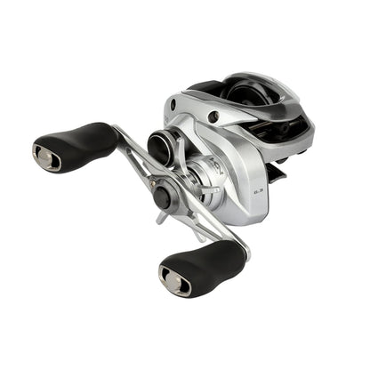The Shimano Tranx 150A Casting Reel 6.3:1 Right Hand (TRX150A) by Shimano features a sleek silver finish with two black handles and metal components, shown on a white background—perfect for saltwater fishing enthusiasts.