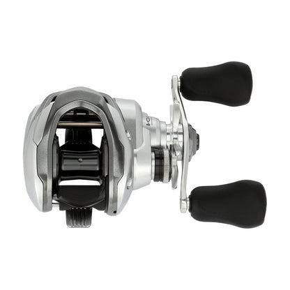 The Shimano Tranx 150A Casting Reel 6.3:1 Right Hand (TRX150A) features a sleek silver and black design with dual black padded handles, shown from above on a white background.