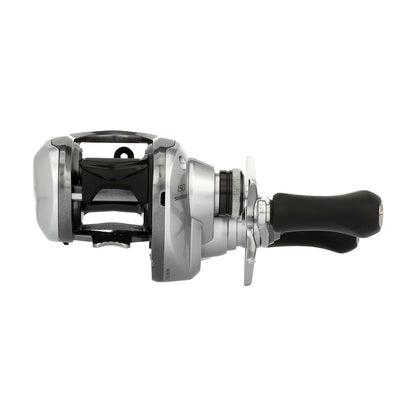 The Shimano Tranx 150A Casting Reel 6.3:1 Right Hand (TRX150A) in silver and black, featuring a double handle grip, is shown side view against a white background—ideal for saltwater fishing.