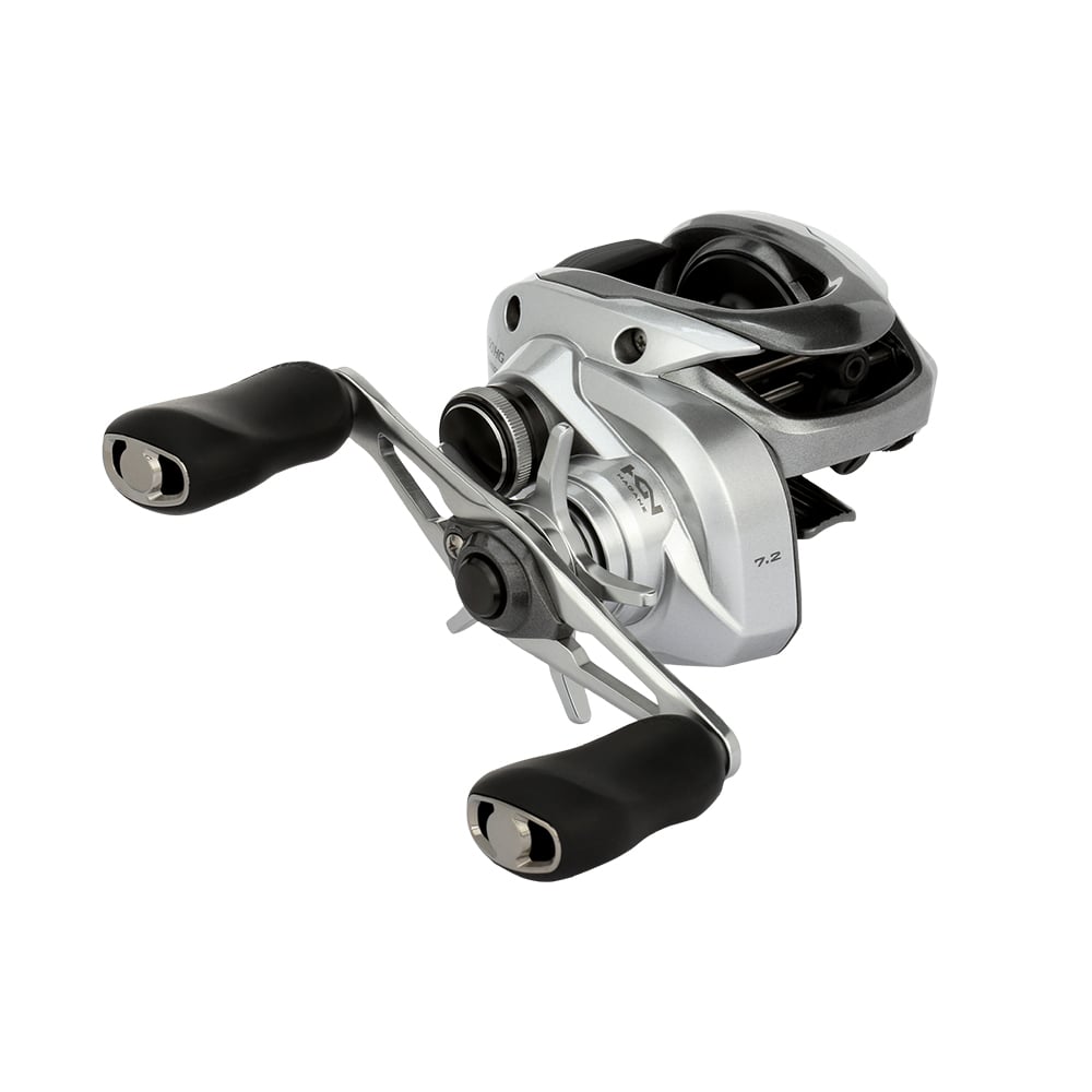 The Shimano Tranx 150A Casting Reel 7.2:1 Right Hand (TRX150HGA) features a silver finish, dual black handle grips, a visible spool, and a compact design—ideal for saltwater fishing—shown on a plain white background.