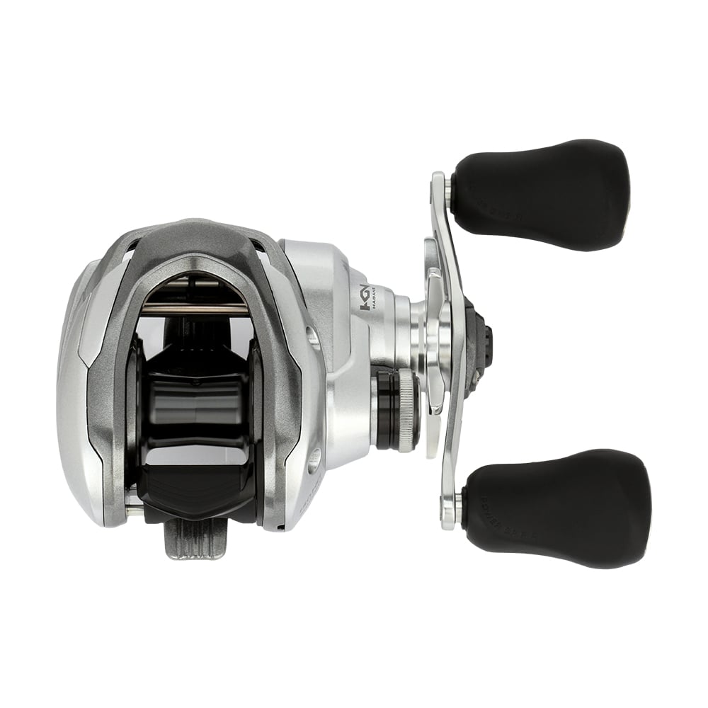 The Shimano Tranx 150A Casting Reel 7.2:1 Right Hand (TRX150HGA) features a silver and black design with two large black rubberized handles, shown from above on a white background—ideal for saltwater fishing.