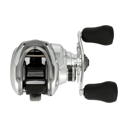 The Shimano Tranx 150A Casting Reel 7.2:1 Left Hand (TRX151HGA) features a silver and black design with two large black rubber handle grips, ideal for saltwater fishing. Brand: Shimano. Shown against a white background.