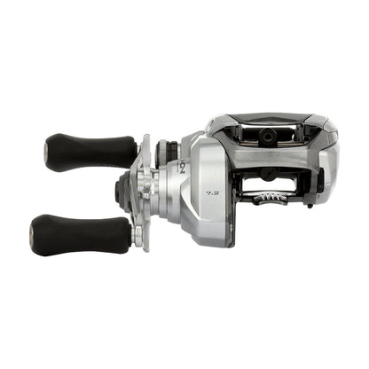 The Shimano Tranx 150A Casting Reel 7.2:1 Right Hand (TRX150HGA) features a silver and black design with two black handles, shown from the side on a white background—perfect for saltwater fishing.