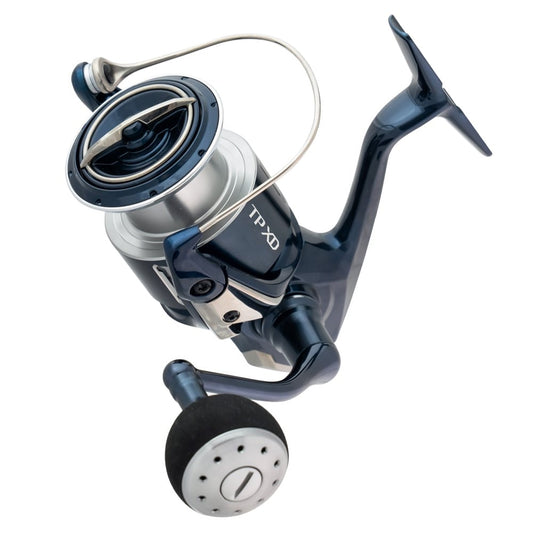 A close-up of the Shimano Twin Power XD Spinning Reel 3000XGFA 6.4:1 (TPXDC3000XGFA), featuring a blue and silver body with a large black handle, isolated on a white background.