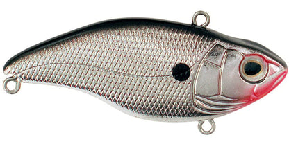 The SPRO Aruku Shad Lipless Crankbait is a shiny silver, fish-shaped lure featuring a black top, pink near the head, a textured scale pattern, and large eye. It's equipped with Gamakatsu treble hooks and two metal rings for line attachment.