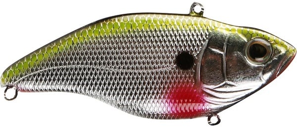A close-up of a SPRO Aruku Shad Lipless Crankbait shows its metallic fish shape with a textured silver body, yellowish-green back, black spot near the center, and red gill area. It features lifelike eyes and sharp Gamakatsu treble hooks.